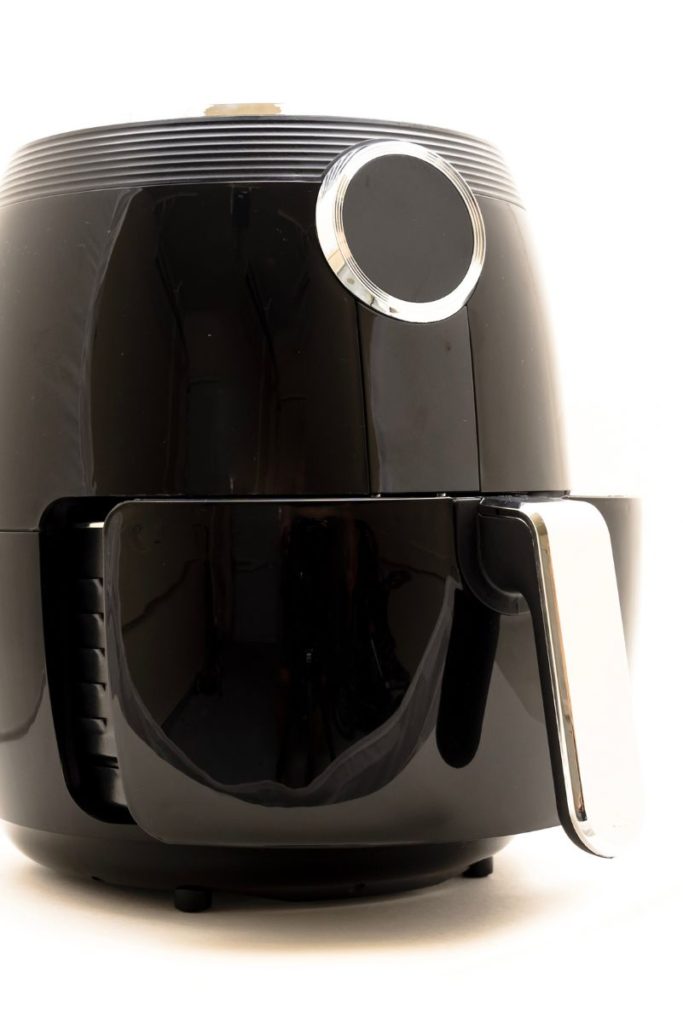 A black air fryer on a solid white background.
