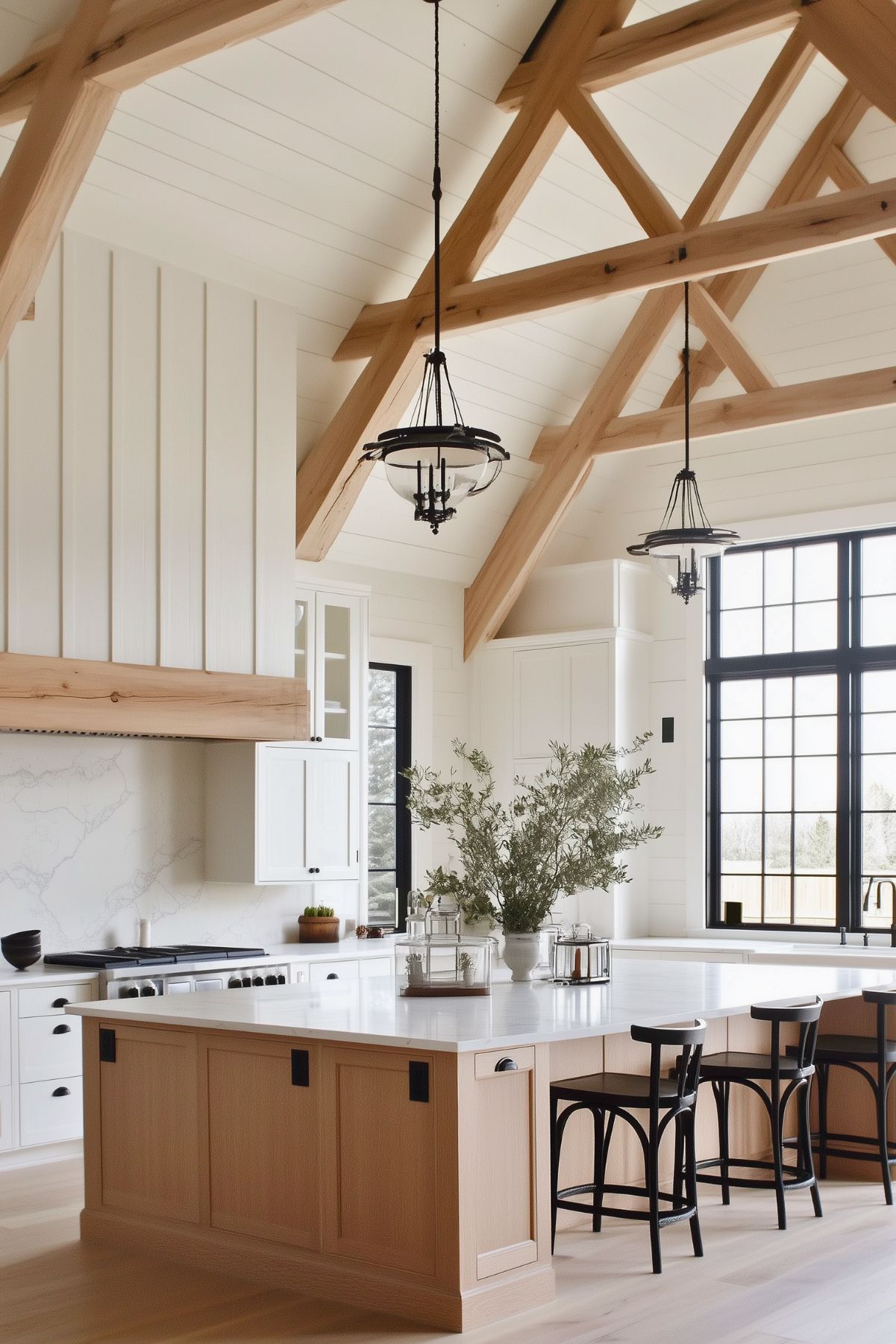 Bright kitchen with white oak cabinets, large island with quartz countertop, industrial pendant lighting, black-framed windows, white subway tile backsplash, and minimalist decor, creating a modern farmhouse aesthetic.