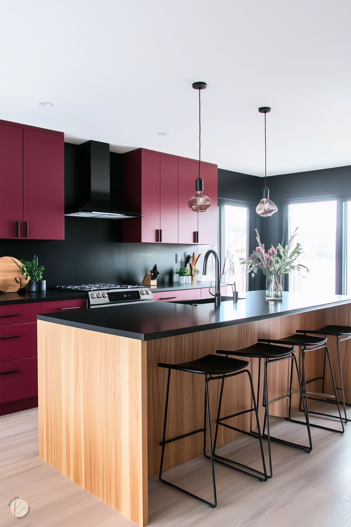 Modern kitchen with burgundy cabinets, black countertops, light wood island, and sleek bar seating, complemented by contemporary pendant lighting.