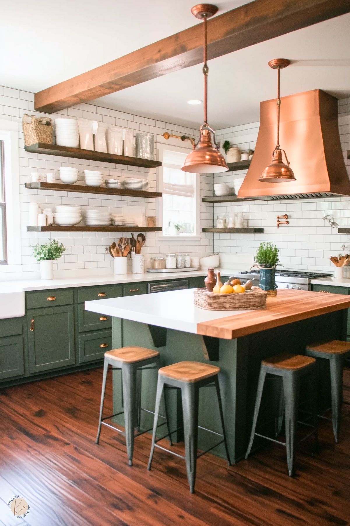 A modern farmhouse kitchen with dark green lower cabinets, brass hardware, and a white farmhouse sink. Open wooden shelves hold white dishware against a white subway tile backsplash. A striking copper range hood and matching pendant lights add warmth and elegance. The central island features a butcher block edge and white countertop, surrounded by industrial-style stools. Rich wooden flooring and a wooden ceiling beam complete the cozy yet stylish look.