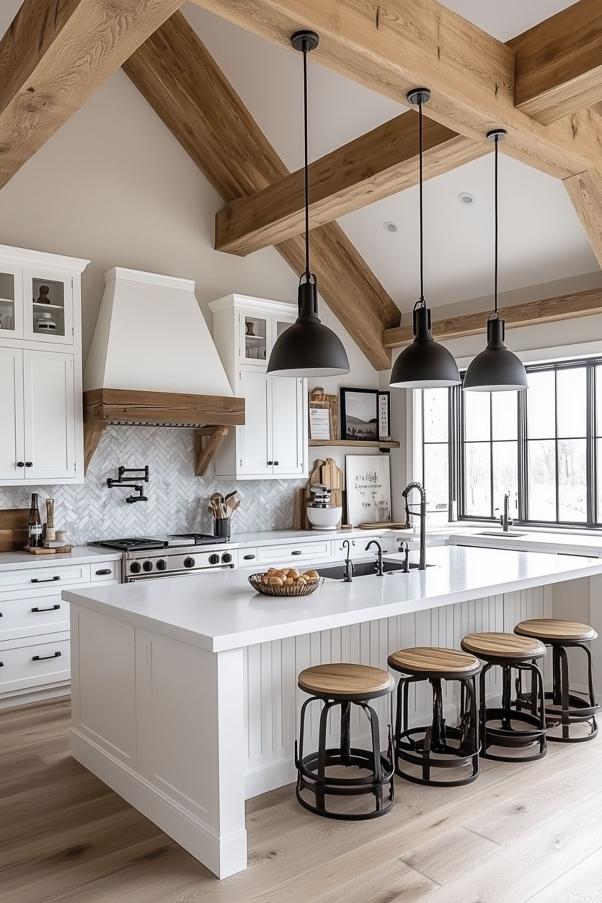 A modern farmhouse kitchen with vaulted ceilings featuring exposed wooden beams. The space includes a large white island with beadboard detailing, paired with rustic barstools with wood seats and black metal frames. Black pendant lights hang above the island, adding a bold accent. The backsplash showcases a herringbone tile design, and white cabinetry surrounds a wood-trimmed range hood. Large windows flood the space with natural light, enhancing its warm, inviting atmosphere.