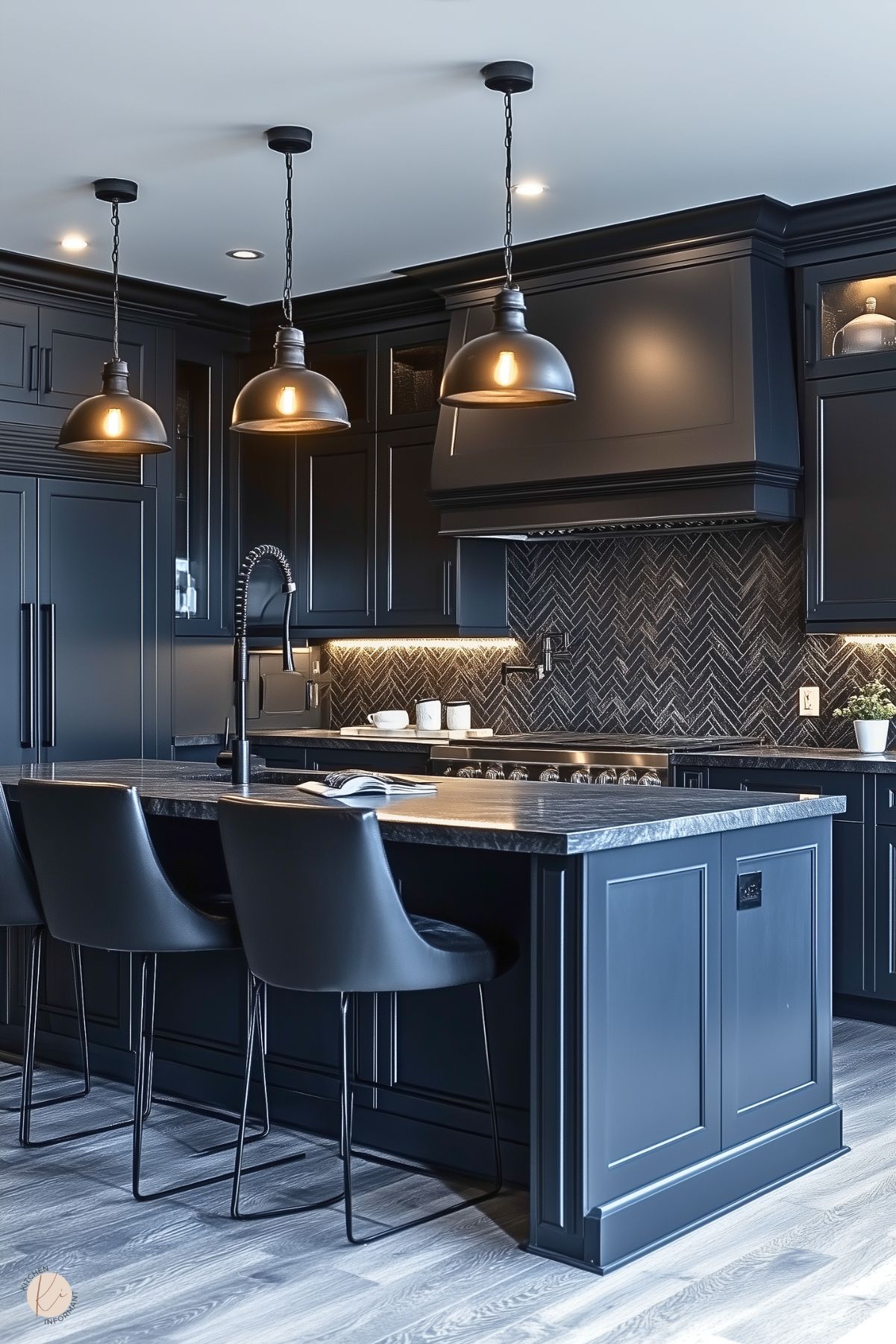 A sophisticated kitchen with sleek black cabinetry, a matching range hood, and a dark herringbone tile backsplash. The large island features a black marble countertop with a modern matte black faucet and comfortable leather barstools. Pendant lights with industrial-style black shades hang above the island, providing a warm glow. Under-cabinet lighting highlights the backsplash, and light wood flooring adds contrast to the moody, elegant design.