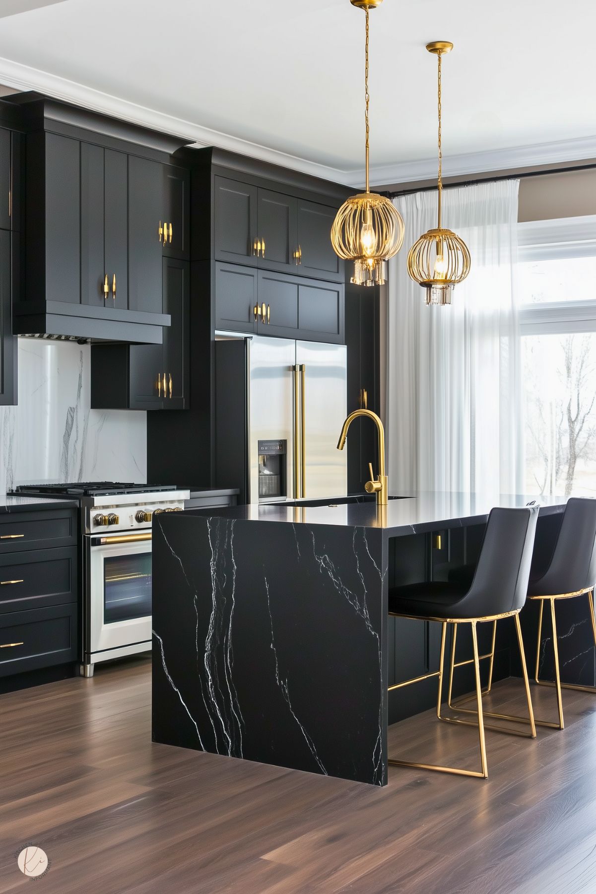 A modern kitchen with sleek black cabinetry, accented by gold hardware and fixtures. The island features a striking black marble waterfall countertop with bold white veining, paired with black bar stools with gold legs. Elegant gold pendant lights hang above the island, while a marble backsplash and stainless steel appliances complement the design. Large windows with sheer curtains brighten the space, adding a soft contrast to the bold decor.