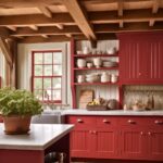 A cozy farmhouse kitchen with deep red beadboard cabinetry, open shelving, and warm wood ceiling beams. A large farmhouse sink sits beneath a red-trimmed window, bringing in natural light. White dishware and rustic kitchen essentials are neatly arranged on the shelves. A potted plant on the island adds a fresh touch, while wooden countertops and plank flooring enhance the rustic charm of the space.