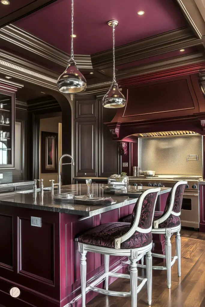 Elegant kitchen with rich burgundy cabinetry, a burgundy coffered ceiling, dark stone countertops, ornate upholstered barstools with white wood frames, and metallic pendant lights, blending luxurious traditional design with dramatic color contrasts.