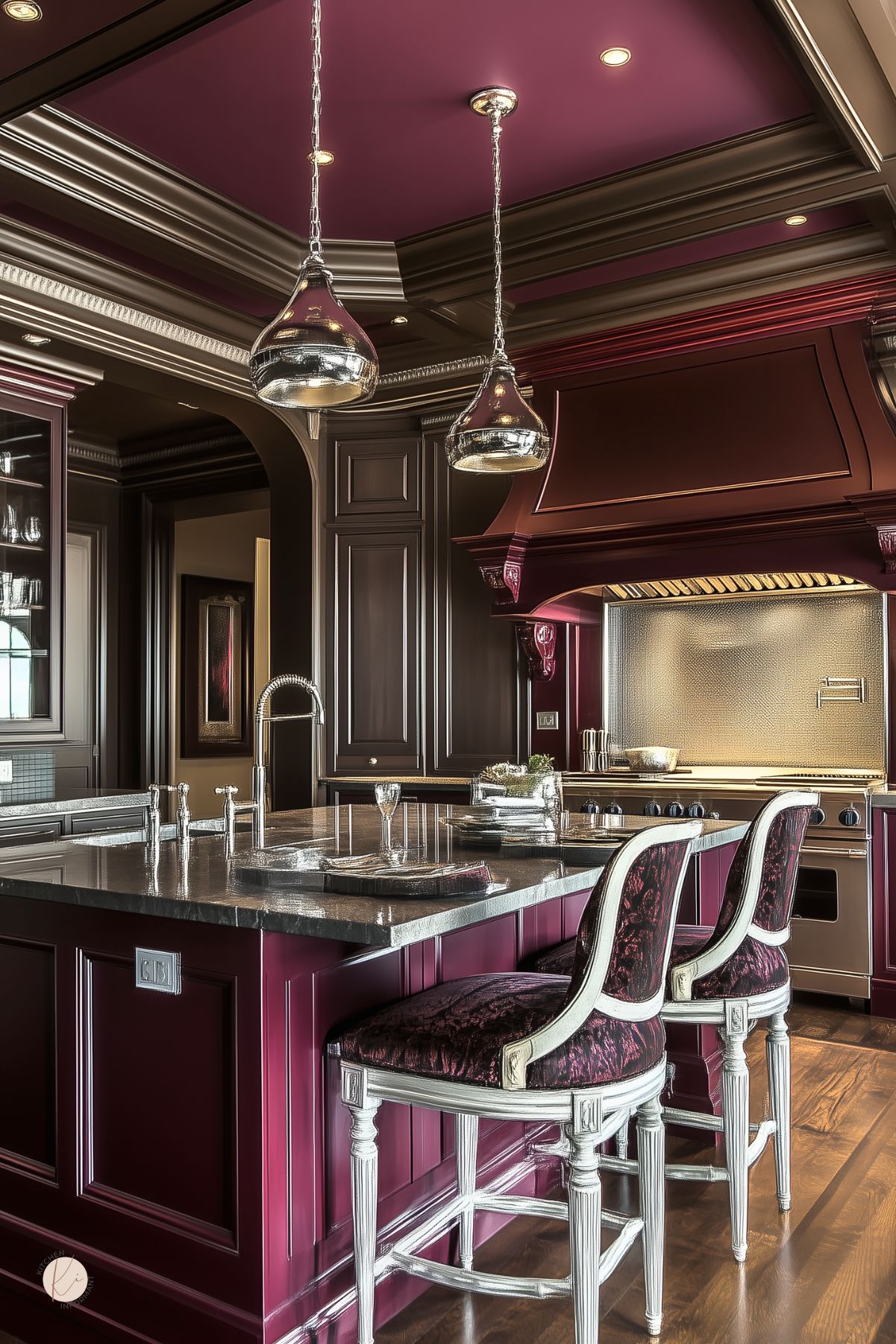Elegant kitchen with rich burgundy cabinetry, a burgundy coffered ceiling, dark stone countertops, ornate upholstered barstools with white wood frames, and metallic pendant lights, blending luxurious traditional design with dramatic color contrasts.