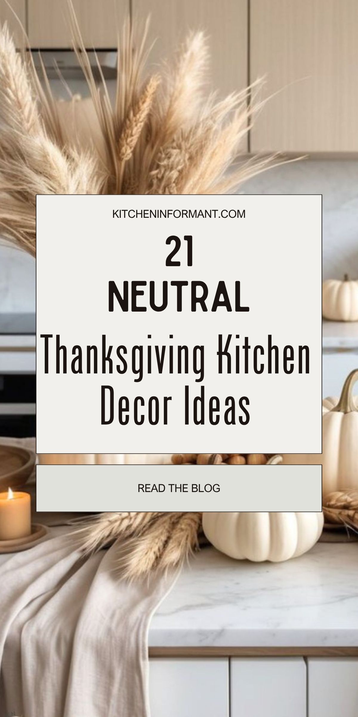 Neutral Thanksgiving kitchen decor in a modern kitchen: pampas grass and wheat in a vase, white pumpkins, a lit candle, and a beige linen runner on a marble countertop with light wood cabinets. Text: KITCHENINFORMANT.COM • 21 NEUTRAL Thanksgiving Kitchen Decor Ideas • READ THE BLOG.