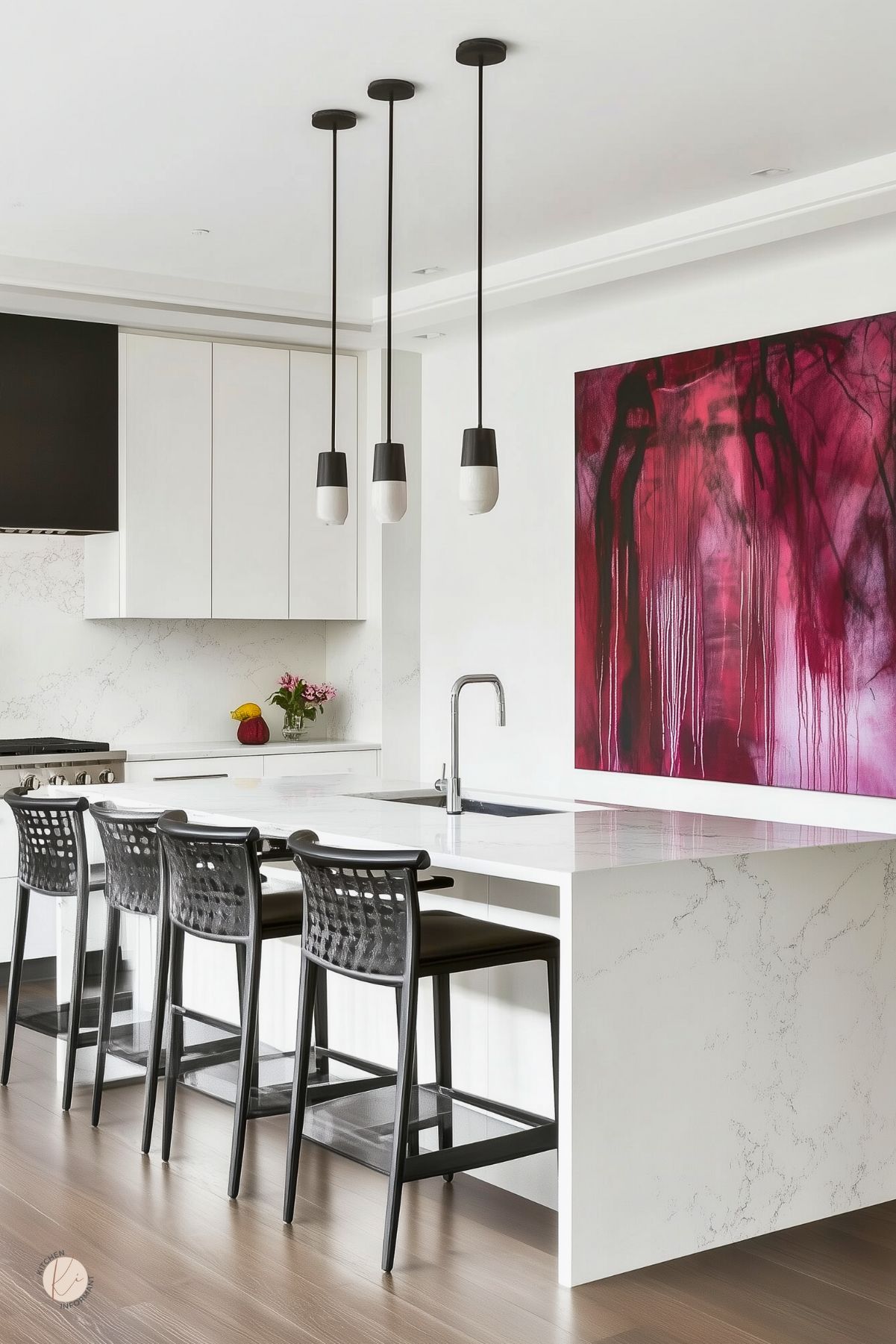 Minimalist kitchen with white cabinetry and a marble waterfall island, paired with black modern barstools and sleek pendant lights. A dramatic abstract burgundy painting on the wall adds a bold pop of color, echoed by a small burgundy vase on the counter.