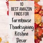 Fall flat lay of rustic farmhouse Thanksgiving kitchen decor: assorted pumpkins, apples, autumn leaves, and red berries arranged around a cream wood background. Center banner text: “10 Best Amazon Finds for Farmhouse Thanksgiving Kitchen Decor.” Small text: kitcheninformant.com. SEO: farmhouse kitchen decor, Thanksgiving decor, fall kitchen, Amazon finds.