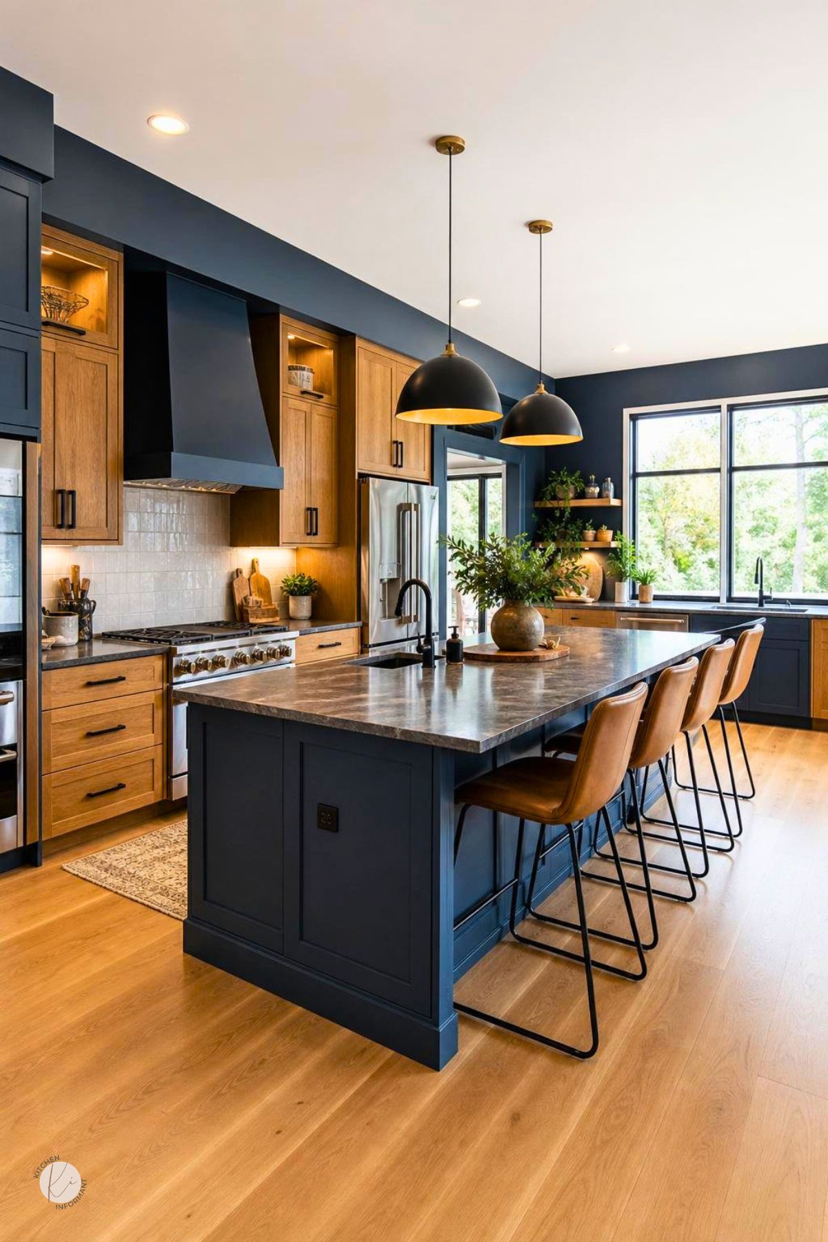 Moody blue kitchen with oak cabinets, a navy blue island, dark stone countertops, black pendant lights, leather bar stools, white tile backsplash, stainless appliances, and light wood flooring.